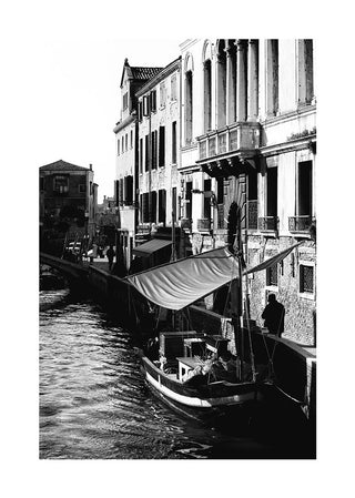 Black and white poster of a boat docked along a canal with historic Venetian buildings in the background.