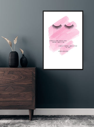 "I Don't Care" poster with pink background, eyelashes illustration, and quote on wall above modern dresser.