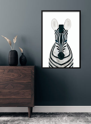 Cute zebra poster for children, framed and hanging on a dark wall above a wooden dresser with decorative items.