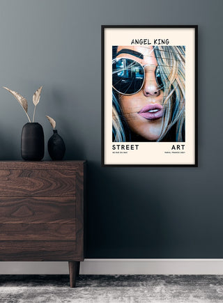 Framed Street Art - Angel King Plakat featuring a close-up of a woman's face with sunglasses and tousled hair.