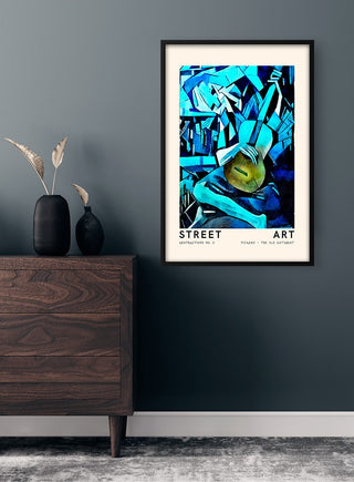 Framed Picasso-inspired Street Art poster with abstract blue shapes hangs above a wooden dresser.
