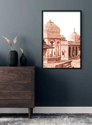 Framed Old Town Square art print with domed architecture hanging above a wooden dresser in a modern room.