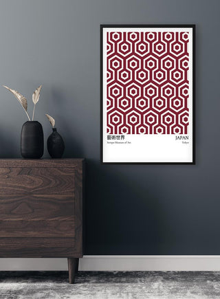 Red From Japan Exhibition Plakat with geometric hexagonal pattern, framed and hung on a dark gray wall above a dresser.