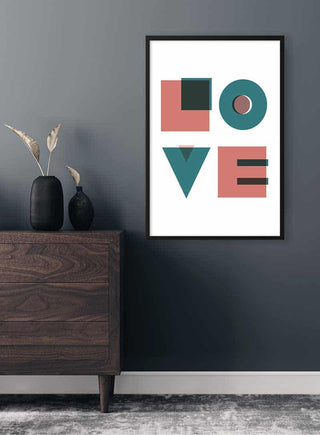 Framed Love Plakat with bold geometric letters on a wall above a wooden cabinet in a modern room.
