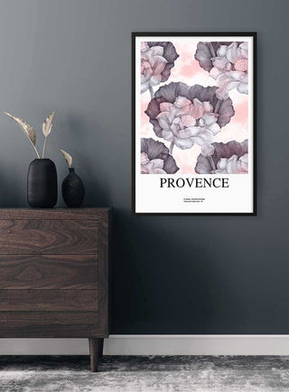 Framed Flowers at Provence Plakat with watercolor floral design hanging on a dark wall above a wooden dresser.