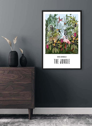 Framed "The Jungle" children's poster with illustrated zoo animals, hanging on a dark wall above a wooden dresser.