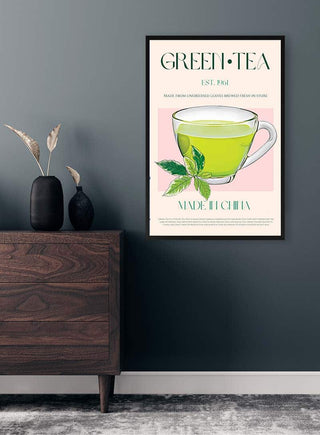Poster of a green tea cup with mint leaves, labeled "Green Tea No2," displayed above a wooden dresser.