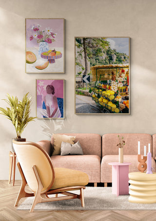 Amalfi Coast Drive XV wall art displayed in a cozy, modern living room with pastel decor and houseplants.