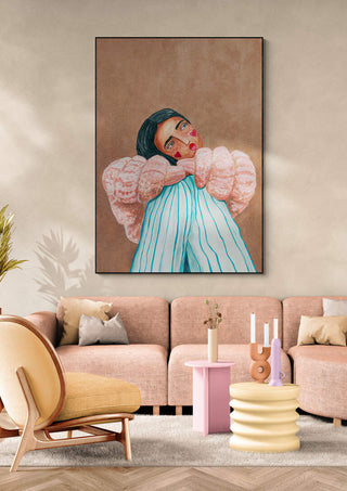 Dreaming girl by Raissa Oltmanns artwork hanging above a modern beige sofa in a stylish living room.