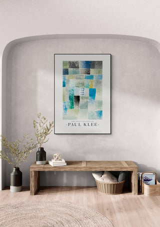 Framed "First House in a Settlement 1926" by Paul Klee displayed above a bench in a modern interior.