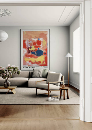A framed Rothko Yellow on Orange poster hangs above a modern beige sofa in a stylish living room.