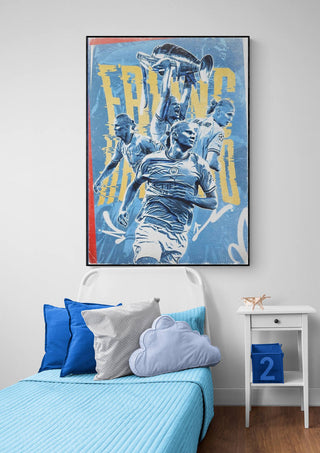 Erling Haaland football poster displayed above a bed with blue bedding and cloud-shaped pillow.