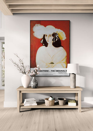 Framed "The White Plumes" by Henri Matisse displayed above a wooden console in a modern living room.
