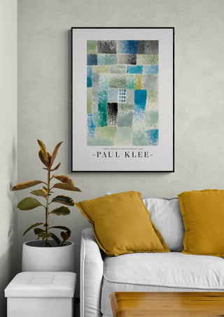 Framed print of Paul Klee's "First House in a Settlement 1926" displayed above a sofa with yellow cushions.