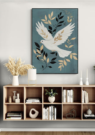 Framed art of a white dove with gold leaves above a wooden shelf, evoking peace and holiday spirit.
