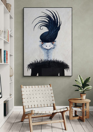 Framed art print of an ostrich with dramatic feathers by Coco de Paris displayed above a modern chair.