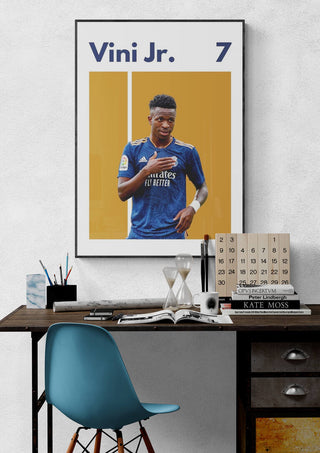 Vini Jr. Real Madrid football poster displayed above a modern desk, showcasing the player in his blue kit.