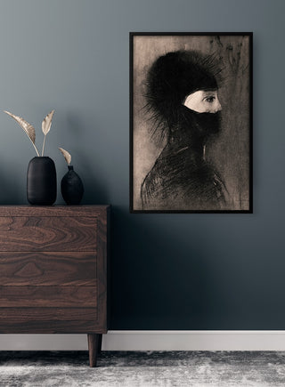Framed "Armor" by Odilon Redon poster displayed on a dark wall above a wooden dresser with vases.