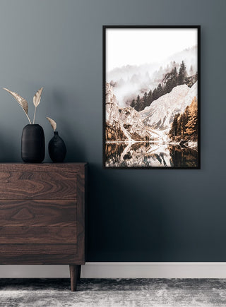 Framed Mountainlake Plakat featuring a serene lake, snow-covered mountains, and pine trees on a modern wall.