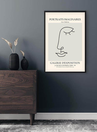 Minimalist Portraits Imaginaires Eye Plakat art print in black frame, displayed above a wooden dresser.