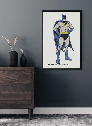 Framed Retro Batman Plakat on a gray wall above a modern wooden dresser with decorative vases.