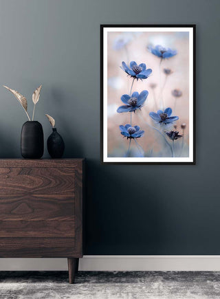 Framed "Cosmos blue" by Mandy Disher on a dark wall above a wooden dresser with decorative vases.
