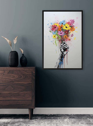 Poster featuring a hand holding colorful flowers, displayed above a wooden dresser in a modern room.