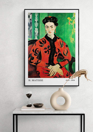 Framed print of Matisse's Madame Rouge hangs above a modern console table with decorative objects.
