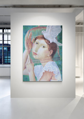 Painting of a woman inside a birdcage with a white dove perched on top, displayed in a bright gallery.