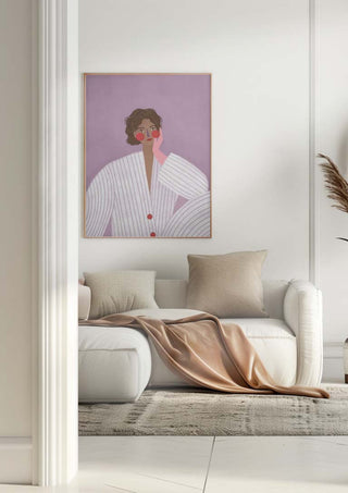 Framed print of "The Woman With the Pink Glove" by Bea Muller hanging above a modern white sofa.