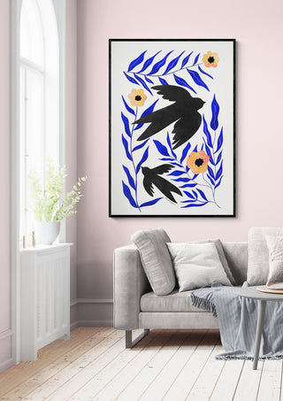 Framed Swallow Flowers - Baroo Bloom artwork with blue leaves and swallows, hanging above a sofa in a modern living room.