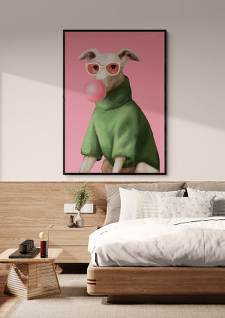Framed print of a dog in pink glasses and green sweater blowing bubblegum, above a modern bed.