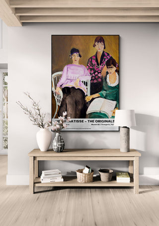 Framed "Les Trois Soeurs" by Henri Matisse displayed above a console table in a modern living room.