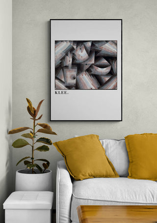 Framed "Crystal gradation 1921" by Paul Klee displayed above a sofa with yellow pillows in a modern living room.