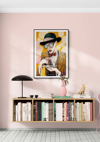 Framed “Drinking Game - Martin Zen” art print on pink wall above modern bookshelf and decor.