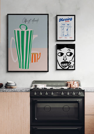Framed coffee pot art print hangs above a modern stove, perfect for coffee lovers' kitchen décor.