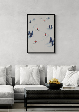 Framed art print of five skiers descending a snowy slope, displayed above a modern sofa in a living room.